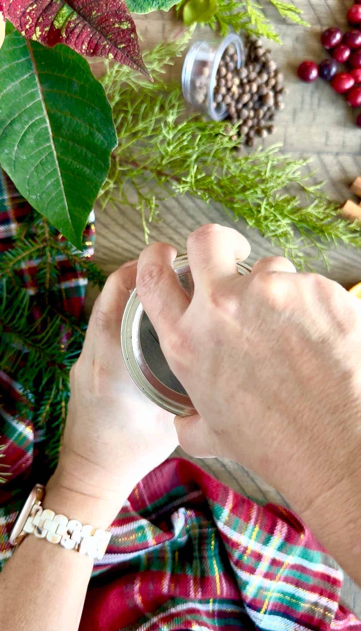 Closing the lid of the complete Winter Simmer Pot Jar.