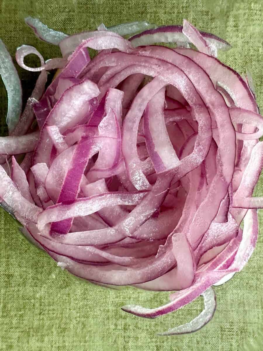Thinly sliced red onions marinated with salt and lemon juice.