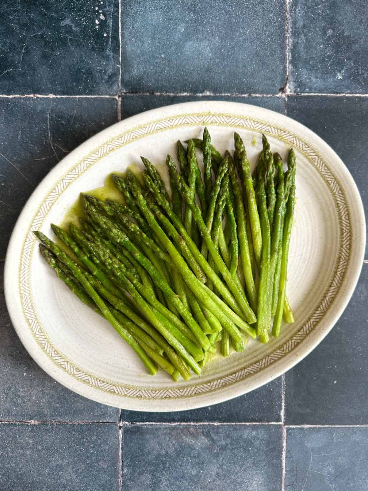 Asparagus in their own Juices on an oval plate.