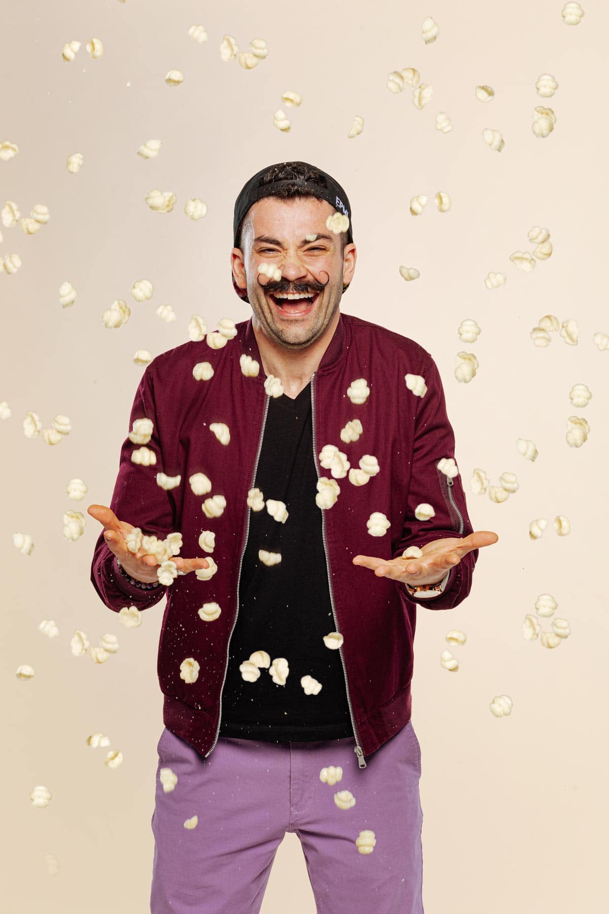 Joe Sasto throwing a snack smiling.